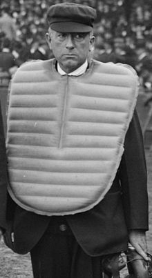 Umpire Bill Connolly wears balloon chest protector and plate coat