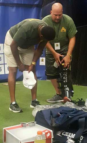 Instructor shows student how to fit umpire shin guards