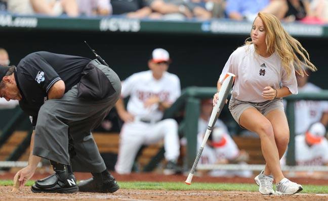 Umpires Bends Over to Brush Off Plate