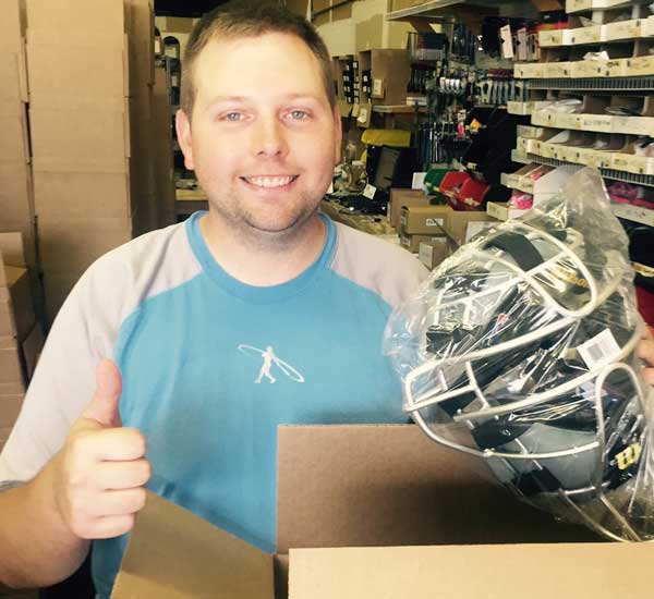 Brandon Lawson Holding Mask in Warehouse