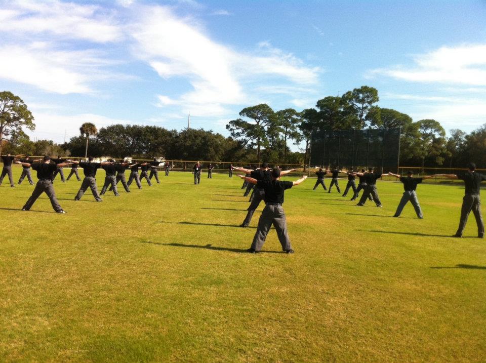 Umpire School students in formation making safe call